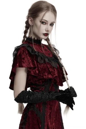 Female model in complete gothic outfit wearing long velvet arm gloves - front full body view with Victorian makeup