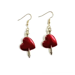 Gold arrow pierced red heart drop earrings gothic style jewelry flat lay front view