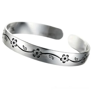 Polished silver bangle with detailed gothic flower engraving, front flat view showcasing the full floral design pattern