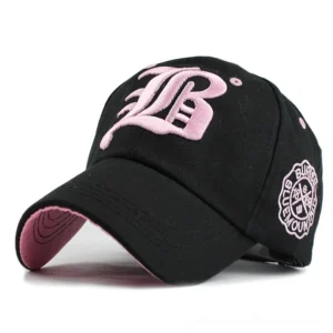 Black gothic baseball cap with pink 3D embroidered letter logo, three-quarter front view showing alternative style design