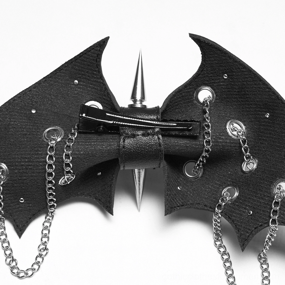 Front close-up detail of gothic bat wing clip with central metal spike and multiple rivets
