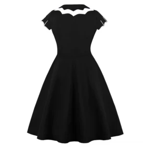 Black gothic A-line dress rear view showing fitted waist, flared skirt silhouette, and short cap sleeves with scalloped trim detail
