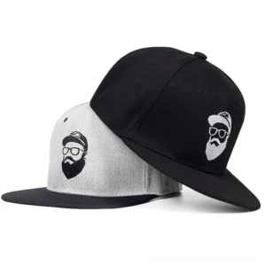 Black and heather grey gothic snapback hats stacked together, featuring embroidered bearded character artwork, side-front angle