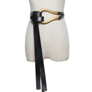 Black PU leather gothic belt with gold U-shaped metal buckle worn on mannequin, front view showing dramatic hanging ends and statement hardware