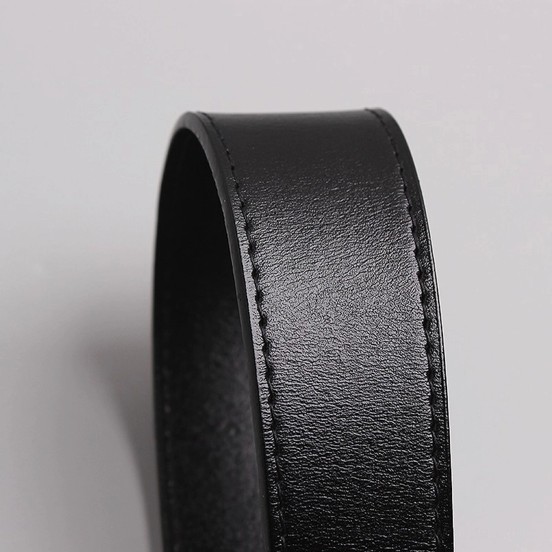 Close-up detail of stitched seam edge of glossy black genuine leather corset belt