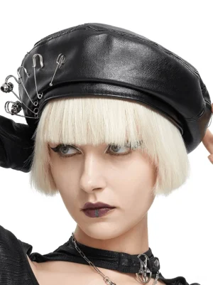 Front three-quarter angle of black leather gothic beret with metallic safety pins, styled with gothic choker necklace