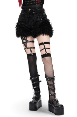 Black faux leather gothic shorts with fur trim worn by model, front view showing harness straps and fluffy fur hem