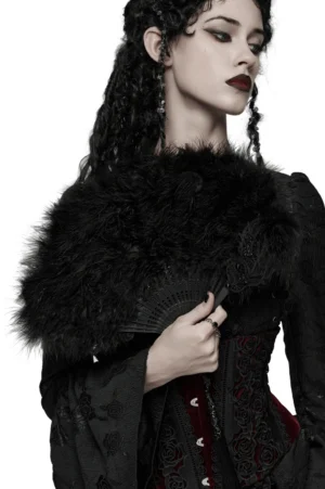 Black gothic feather hand fan with ornate cross pendant worn as shoulder accessory on female model in studio
