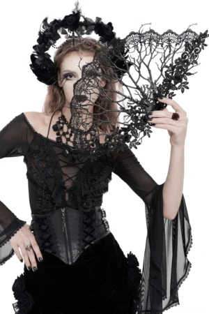 Female model wearing gothic black lace hand fan with floral branch detail, paired with dark gothic headpiece and makeup, front three-quarter view