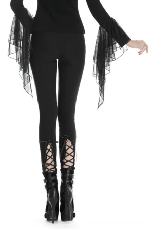 Rear view of black gothic lace leggings worn by female model with coordinating sheer lace top, highlighting ankle drawstring lace-up details