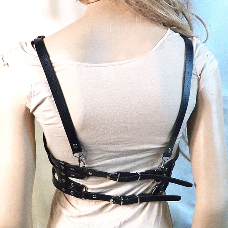 Black PU leather heart harness bra back view, revealing rear adjustable straps and metal buckle closure system for gothic body chain wear