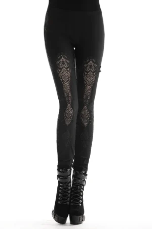 Black gothic lace-up leggings with thigh lace inserts worn by model in studio, front low-angle view showing lace panel details and ankle lace-up design