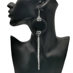 Black rubber hoop drop earrings with silver chain tassels, side view on jewelry mannequin, showcasing gothic statement jewelry
