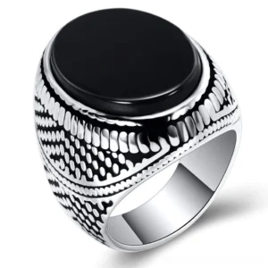 Men's black stone gothic signet ring with vintage silver plating and embossed dotted texture - front and side oblique view