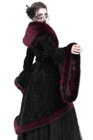 Rear three-quarter view of black velvet gothic coat displaying high-low hemline, fur-trimmed back details, and lace side panels