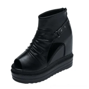 Gothic black wedge platform ankle boots with peep toe front oblique view showing ruched upper and buckle detail