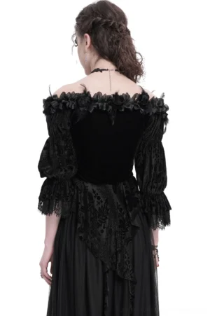 Black gothic velvet blouse rear view showing asymmetrical lace hem, sheer lace sleeves, and braided styling on model