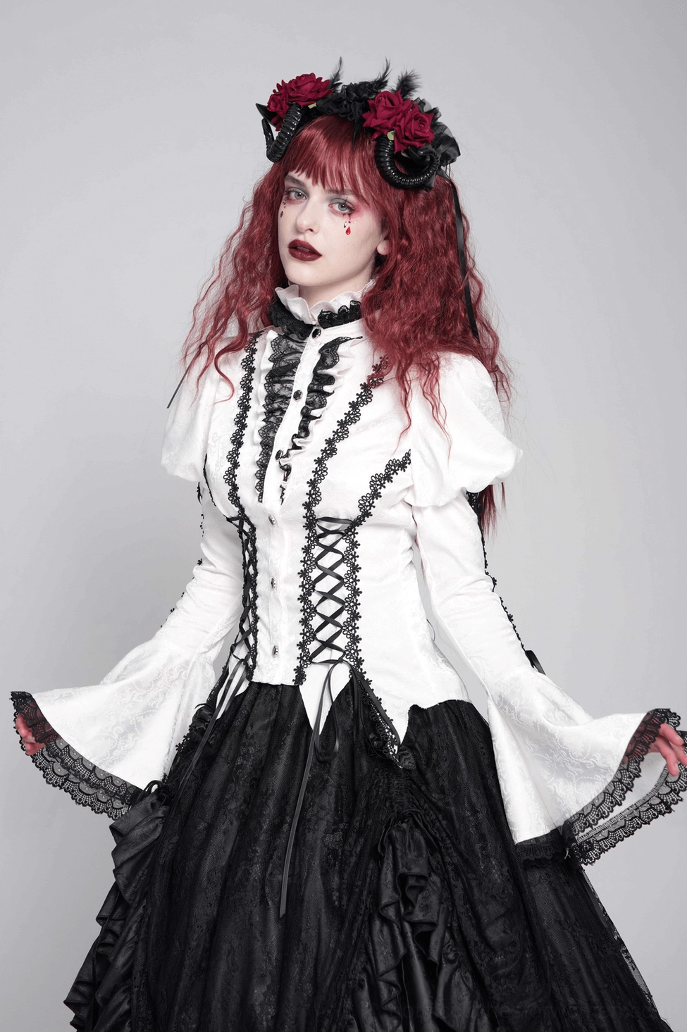 White victorian gothic lace blouse sleeve detail showing bell flare, lace trim, and dramatic sleeve construction
