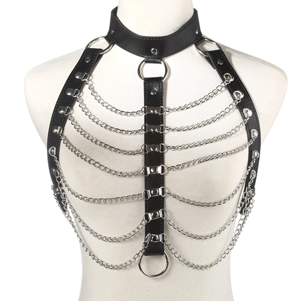 Black hollow-cut PU leather body chain harness with metal O-rings and layered chains on mannequin