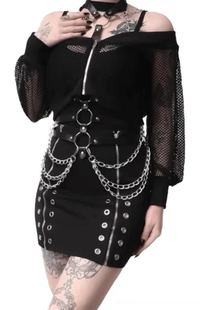 Gothic PU leather body harness with silver chain details and O-ring hardware worn by tattooed model, styled with off-shoulder mesh mini dress for dramatic effect