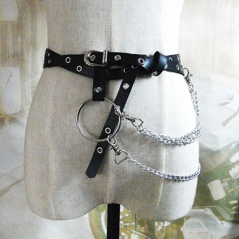 Black leather gothic body harness with large metal ring and double chain clasps, front view on beige mannequin