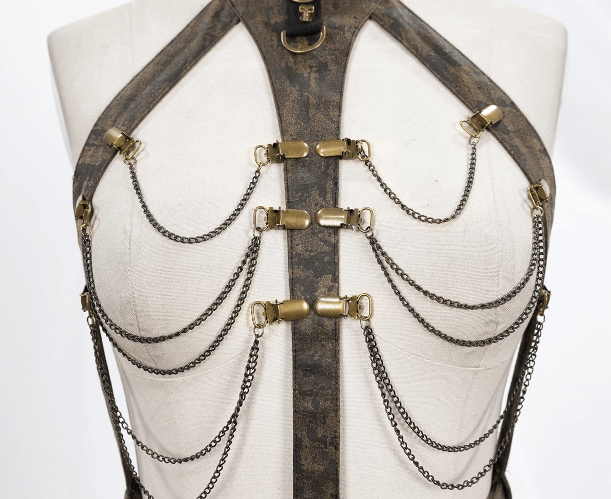 Gothic harness styling showcase featuring decorative chains and leather strap configuration on dress form