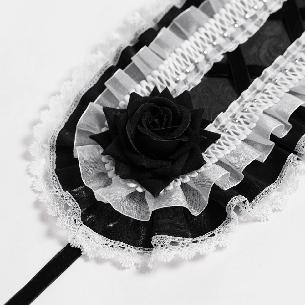 Extreme close-up of gothic lace bonnet showing sheer ruffle texture, velvet black rose, and delicate lace trim