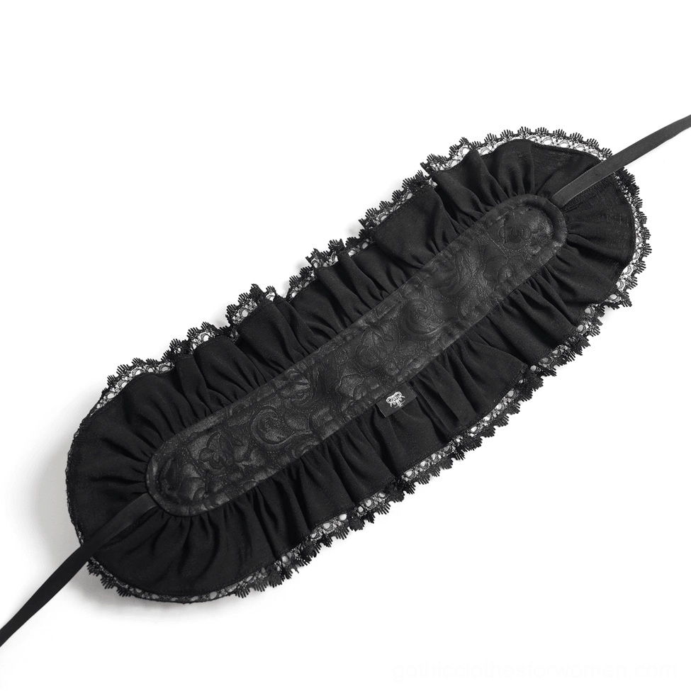 Flat lay overhead view of gothic bonnet on black background featuring ruffled lace, fabric rose, and cross strap design