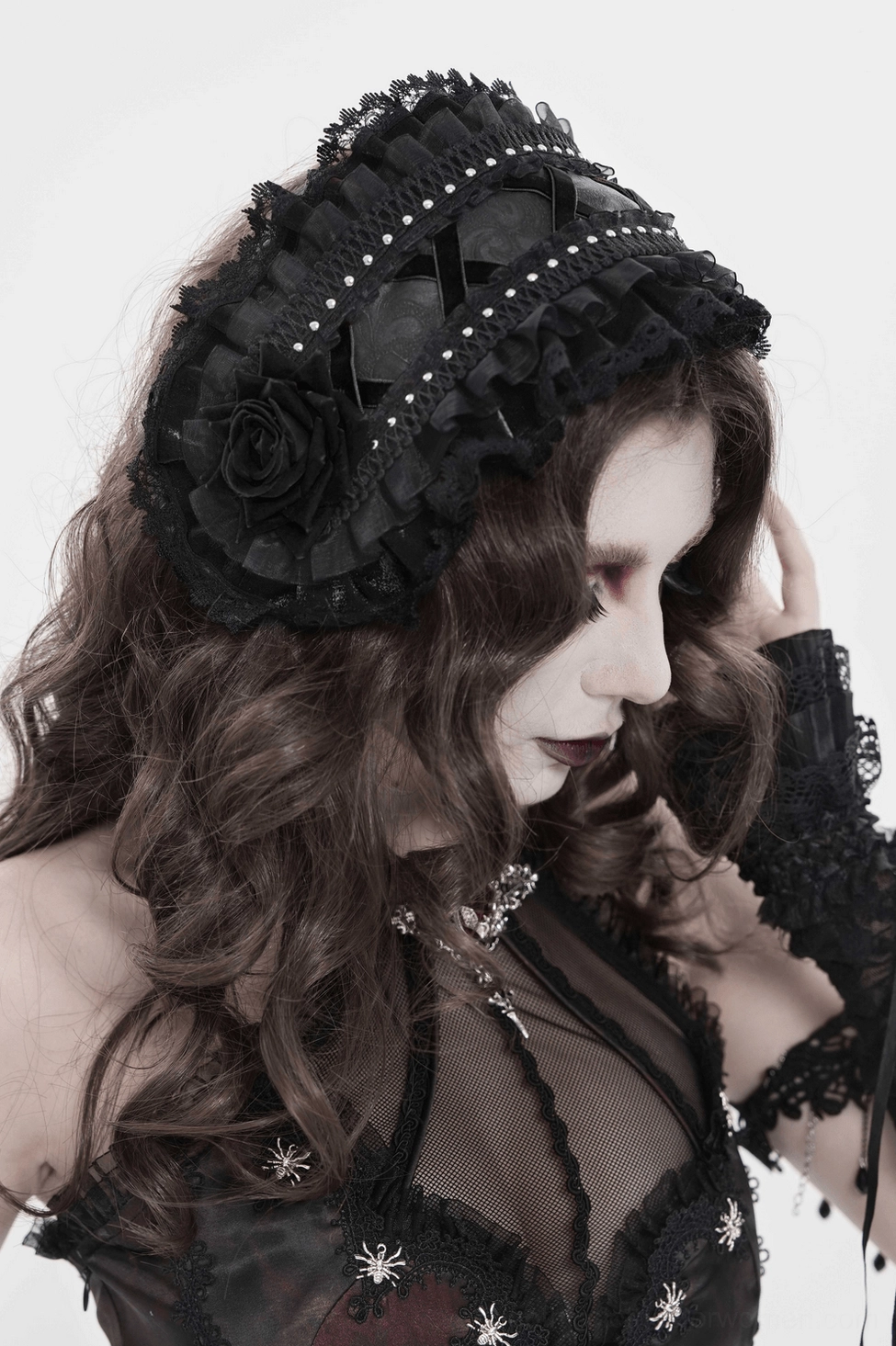 Black gothic lace bonnet full view on white background featuring all design elements including ruffles, roses, and ribbon tie straps