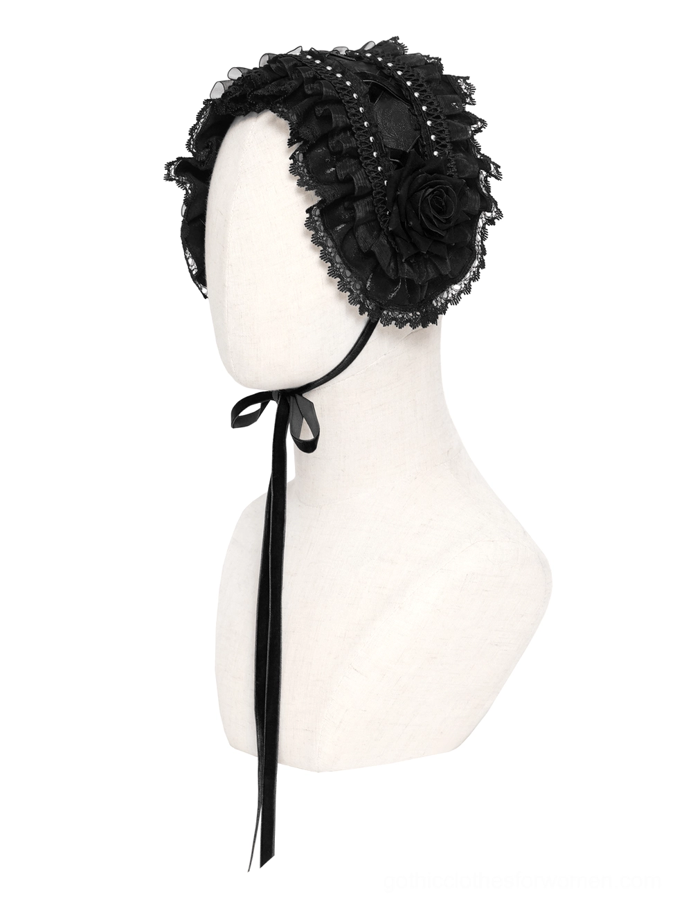 Gothic lace bonnet with long black ribbon tie displayed on mannequin head, front view on white background showing neat lace trim