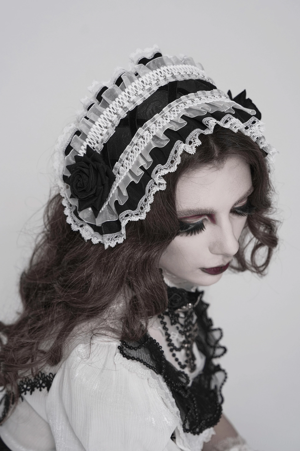 Alternative angle of gothic lace bonnet showing sheer ruffled layers and white lace construction details