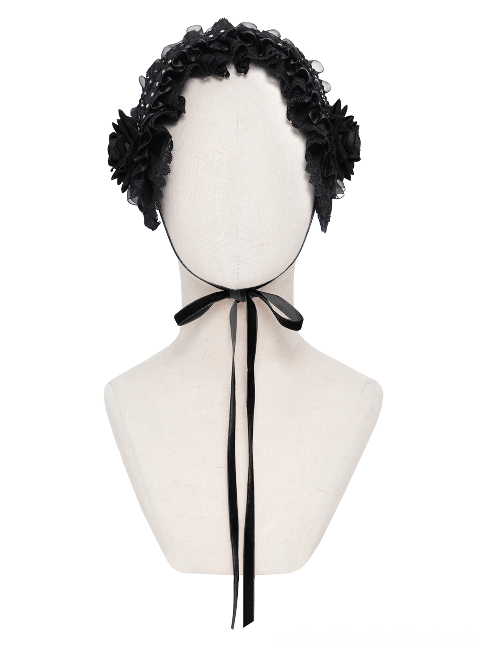 Front view of black gothic lace bonnet on mannequin with dark studio background featuring cross decor, emphasizing gothic aesthetic