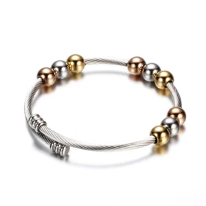 Gothic cuff bracelet side view showing spring-adjustable clasp, mixed metal beads, and twisted cable construction detail