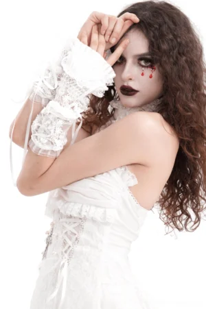 White lace fingerless gothic gloves with ruffled cuffs and ribbon details on model with gothic makeup and curly hair