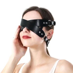 Black leather bunny ear eye mask with criss-cross straps and metal D-rings, front three-quarter view on model