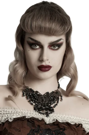 Black gothic butterfly lace necklace worn as choker with bronze hardware and natural stone accents on model with retro makeup and styling