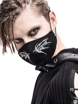 Black gothic butterfly wing face mask modeled by person with braided dreadlocks, three-quarter close-up view showcasing white wing print detail