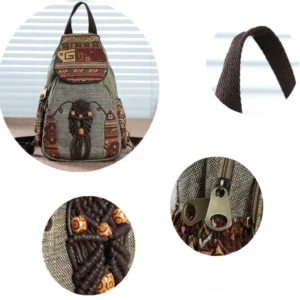 Dark bohemian canvas backpack showing embroidered flap cover and tribal side decorations in indoor setting