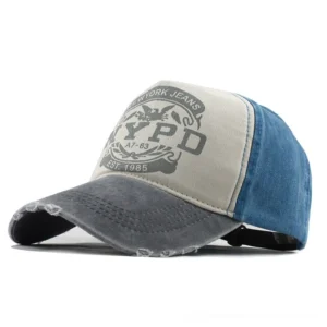 Alternative baseball cap with NYPD print in gray and blue color combination, featuring intentional fraying and 5-panel structure, studio shot