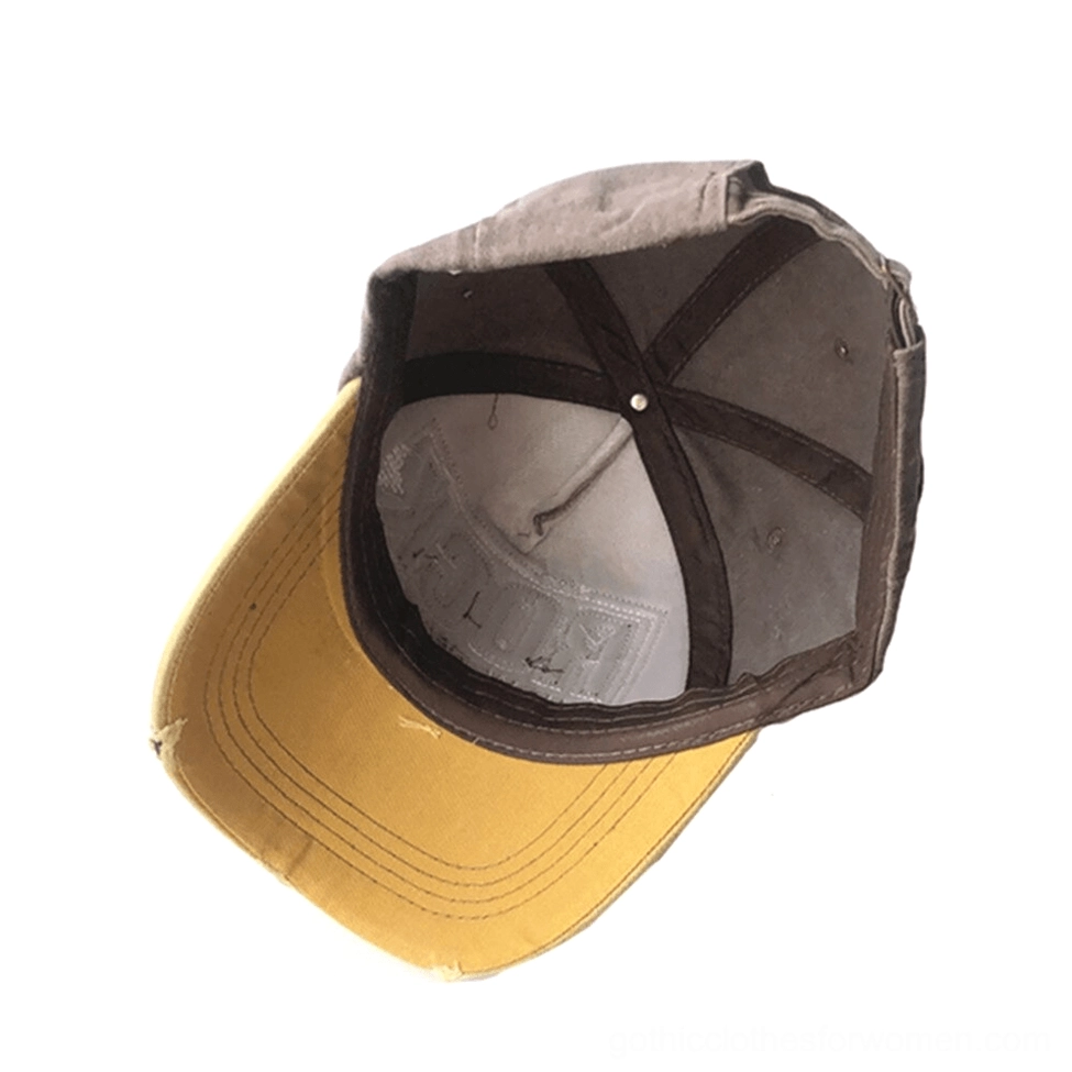 Interior view of gothic baseball cap showing brown exterior with yellow brim, adjustable back strap, reinforced stitching detail