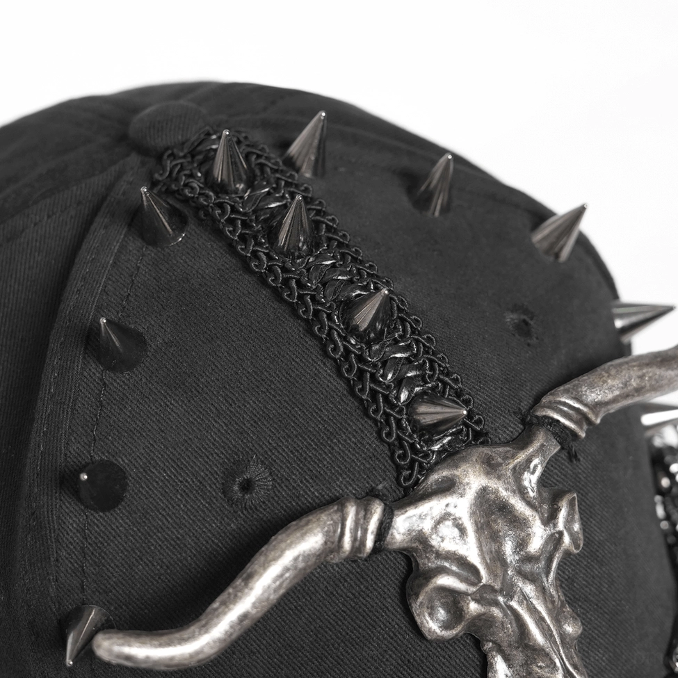 Black gothic baseball cap with spike and chain trims displayed showcasing alternative fashion aesthetic