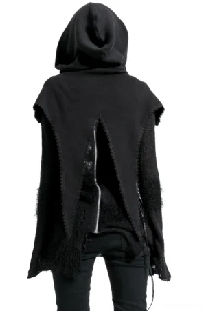 Rear view of black gothic hooded cape showing asymmetrical split hem, functional rear zipper, and attached hood on female model in studio setting