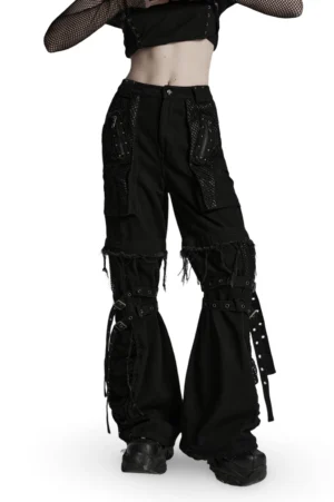 Black detachable gothic cargo pants with mesh pockets and studded straps, front three-quarter view on model