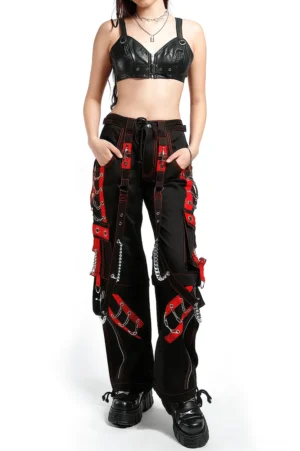 Woman wearing black gothic chain cargo pants with leather crop top full body front view alternative fashion styling