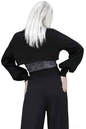 Rear view of black cropped zip-up gothic jacket showing back silhouette and exposed midriff on model