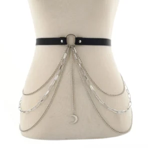 Mannequin display of gothic waist chain harness featuring mixed silver chain links and crescent moon charm with central O-ring fastener