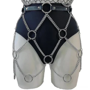 Chain body harness on mannequin, front waist-thigh angle displaying silver crisscross chain lattice with round metal rings against white studio background