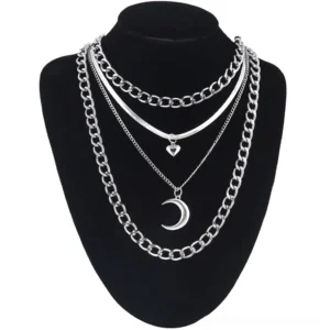 Layered gothic chain necklace with heart and moon silver pendants on black mannequin, alternative fashion styling
