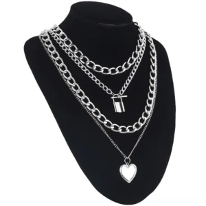 Layered gothic chain necklace with lock and heart charms on black mannequin, showing mixed chain link styles and pendant arrangement