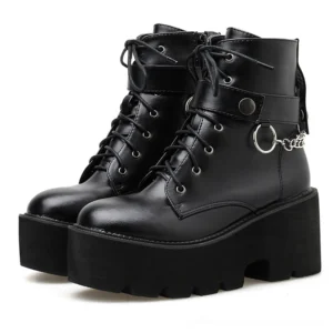 Black gothic chain platform ankle boots front three-quarter view, featuring metal curb chain ornament and chunky lug sole on white background
